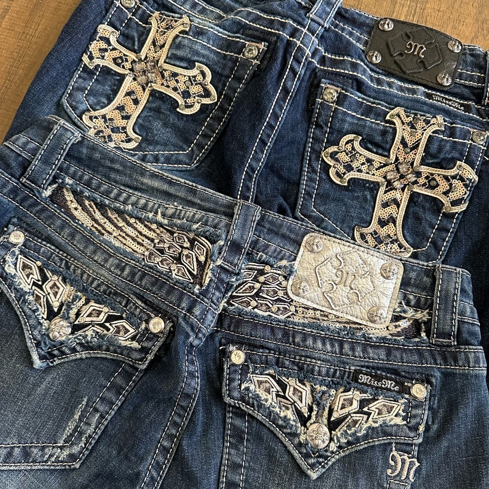 Two pairs of Miss Me Jeans with Cross & wing Embellishments bootcut and straight